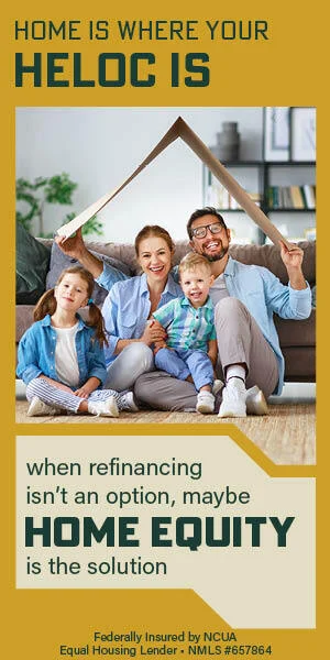 Family sitting in living room holding cardboard roof over their heads
