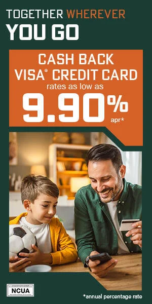 Man holding phone and credit card sitting next to son in house